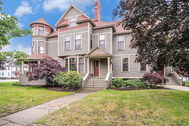 318 Houston Ave, Muskegon, MI 49441 - victorian-style house featuring a front yard and a chimney