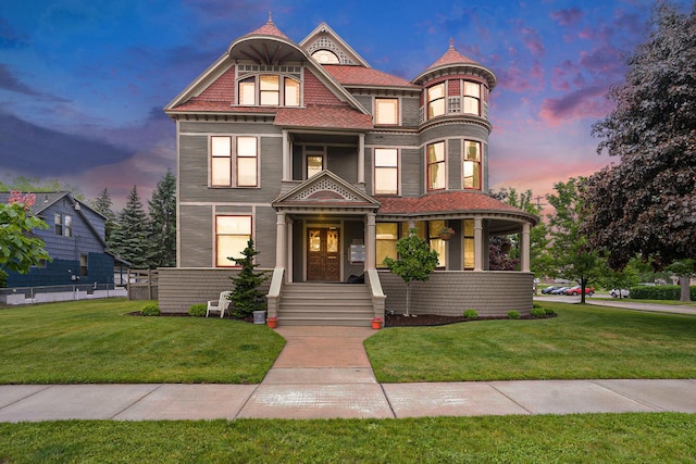 318 Houston Ave, Muskegon, MI 49441 - victorian-style house with a lawn and covered porch