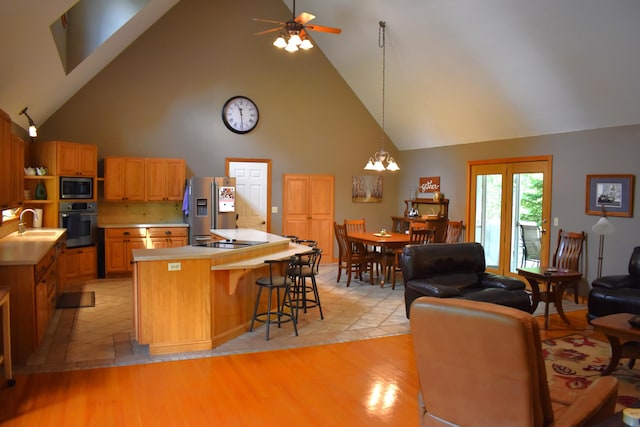 226 N 176th Ave, Walkerville, MI 49459 - kitchen featuring stainless steel appliances, high vaulted ceiling, a ceiling fan, a sink, and light countertops
