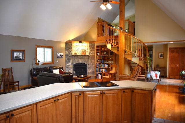 226 N 176th Ave, Walkerville, MI 49459 - kitchen featuring open floor plan, a stone fireplace, a ceiling fan, light countertops, and high vaulted ceiling
