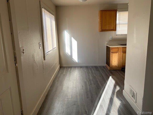 319 S Anderson Ave, Southfield, MI 48342 - unfurnished dining area featuring dark wood-style floors and baseboards