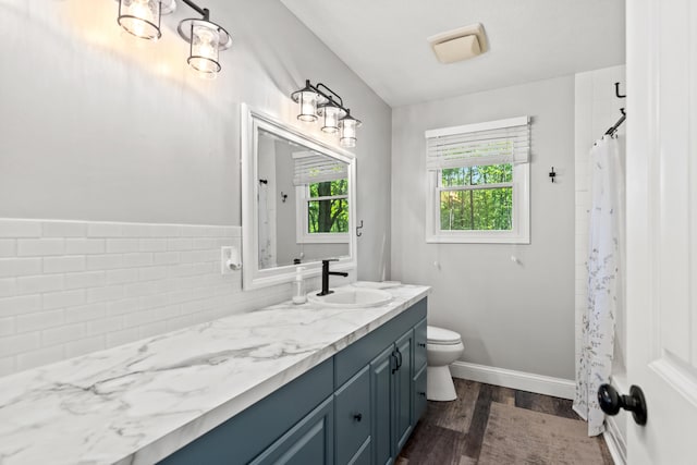 2980 N Old State Rd, Weidman, MI 48893 - full bath featuring vanity, wood finished floors, toilet, curtained shower, and baseboards