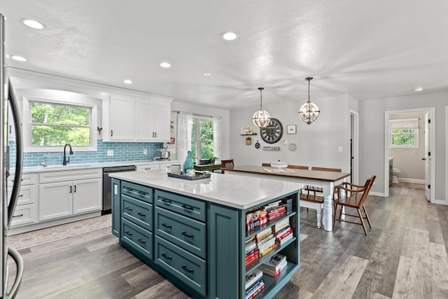 2980 N Old State Rd, Weidman, MI 48893 - kitchen featuring white cabinets, a sink, light countertops, plenty of natural light, and recessed lighting