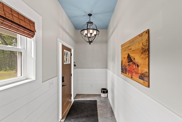 2980 N Old State Rd, Weidman, MI 48893 - doorway to outside featuring a chandelier and wainscoting