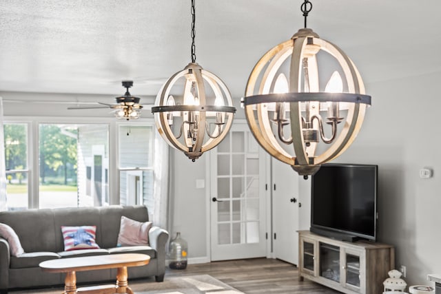 2980 N Old State Rd, Weidman, MI 48893 - living room with wood finished floors, a chandelier, and a ceiling fan