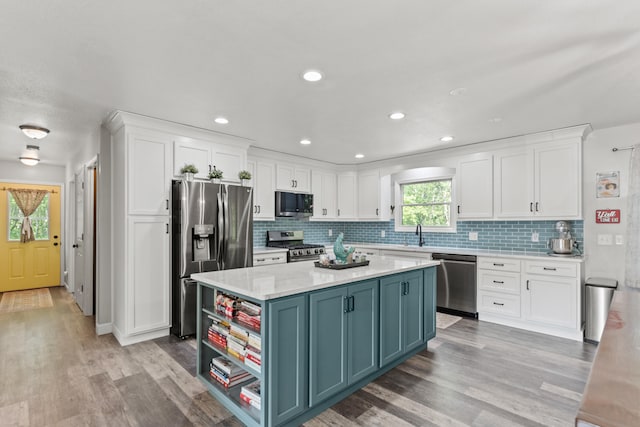 2980 N Old State Rd, Weidman, MI 48893 - kitchen with stainless steel appliances, white cabinets, light countertops, backsplash, and recessed lighting