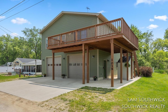 1034 Thompson St SW, Stanton, MI 48888 - rear view of property featuring a garage, a wooden deck, a lawn, and driveway