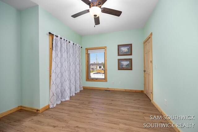 1034 Thompson St SW, Stanton, MI 48888 - empty room featuring wood finished floors, baseboards, and ceiling fan
