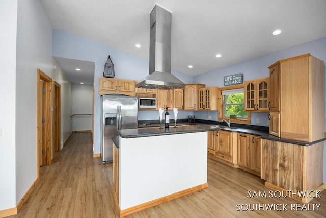 1034 Thompson St SW, Stanton, MI 48888 - kitchen with stainless steel fridge, white microwave, island range hood, a sink, and dark countertops