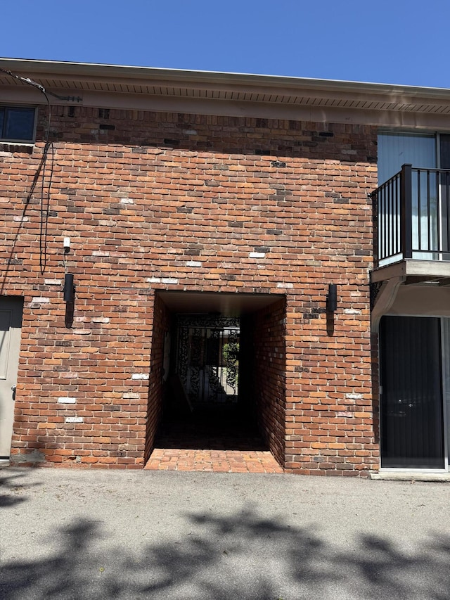 620 E Lincoln Ave Unit 5, Royal Oak, MI 48067 - view of exterior entry featuring brick siding and a balcony