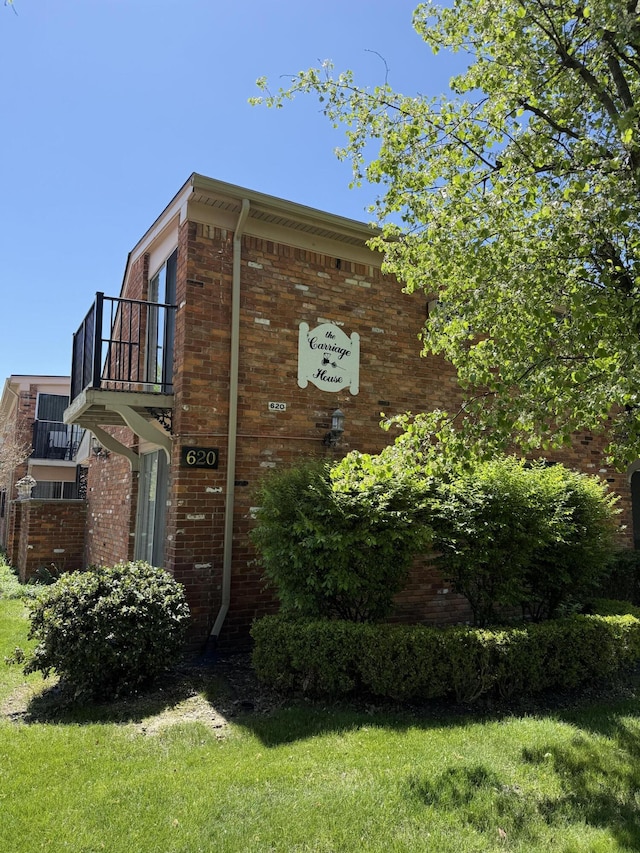 620 E Lincoln Ave Unit 5, Royal Oak, MI 48067 - view of property exterior featuring brick siding and a balcony