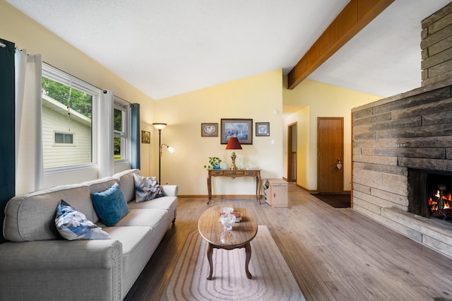 275 Benjamin St, Benton Harbor, MI 49022 - living area with wood finished floors, a stone fireplace, and baseboards