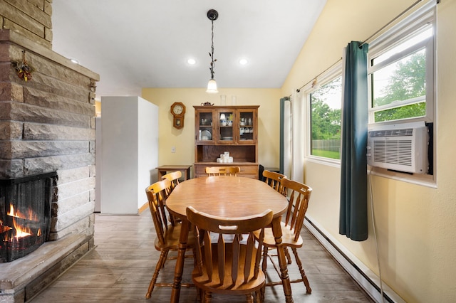 275 Benjamin St, Benton Harbor, MI 49022 - dining space featuring a fireplace, a baseboard heating unit, recessed lighting, wood finished floors, and cooling unit
