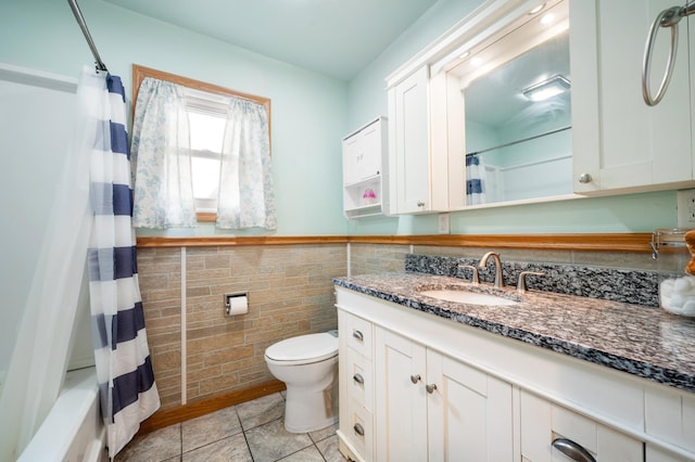 275 Benjamin St, Benton Harbor, MI 49022 - full bath featuring vanity, tile walls, toilet, tile patterned flooring, and wainscoting