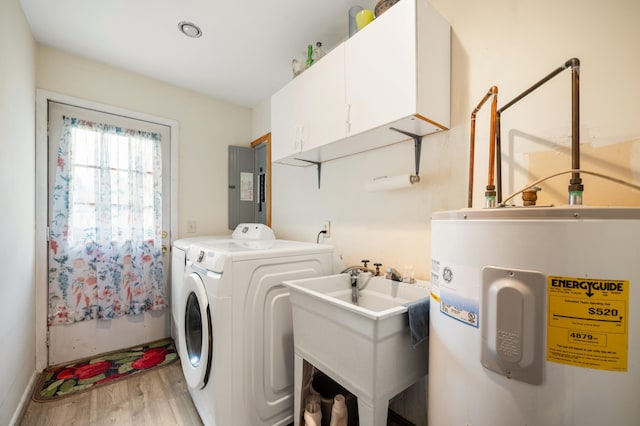 275 Benjamin St, Benton Harbor, MI 49022 - laundry room with electric water heater, cabinet space, light wood-style floors, electric panel, and washer and dryer