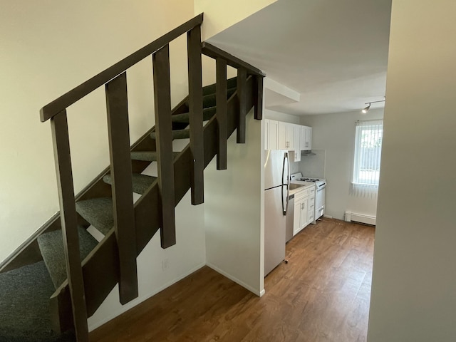 620 E Lincoln Ave Unit 7, Royal Oak, MI 48067 - stairway featuring wood finished floors, a baseboard heating unit, and baseboards