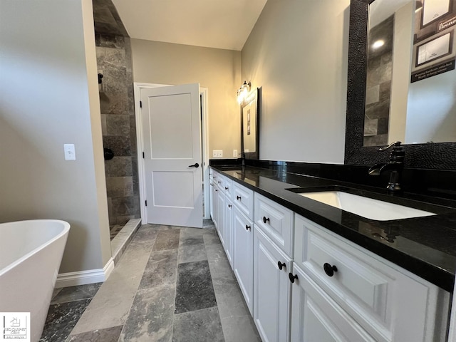 3801 Sutton Rd, Metamora, MI 48455 - full bath featuring double vanity, a soaking tub, a tile shower, baseboards, and stone finish floors