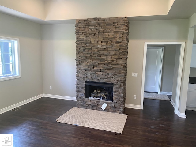 3801 Sutton Rd, Metamora, MI 48455 - unfurnished living room featuring wood finished floors, a fireplace, and baseboards