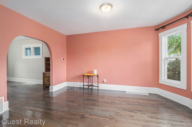 2499 Baldwin St, Detroit, MI 48214 - unfurnished room featuring arched walkways, wood finished floors, and baseboards