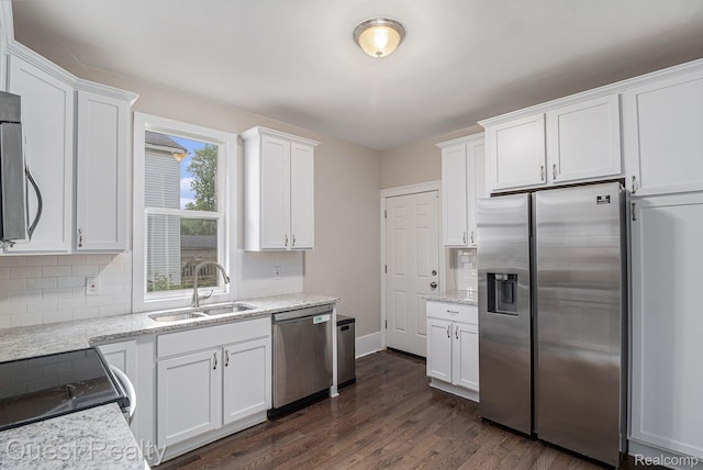 2499 Baldwin St, Detroit, MI 48214 - kitchen with appliances with stainless steel finishes, a sink, decorative backsplash, and white cabinetry