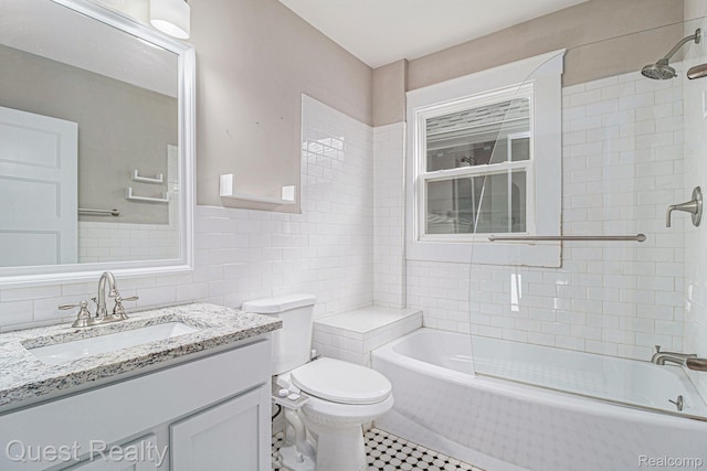 2499 Baldwin St, Detroit, MI 48214 - bathroom featuring tile walls,  shower combination, vanity, and toilet