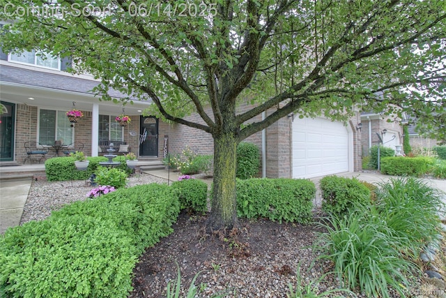 31626 Beaver Cir, New Boston, MI 48164 - view of front of home featuring brick siding, covered porch, and an attached garage