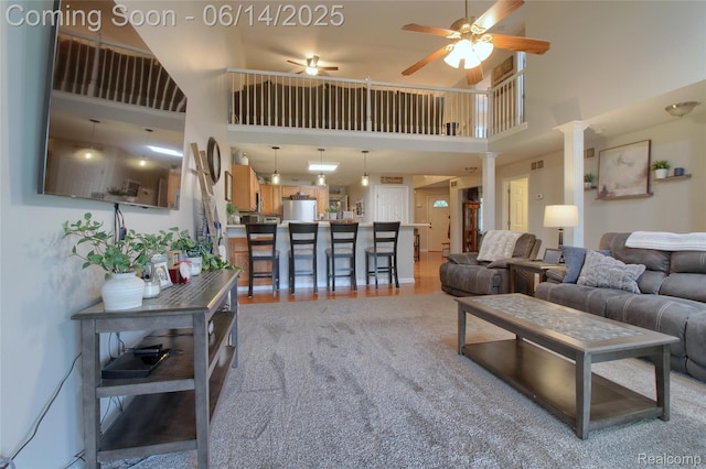 31626 Beaver Cir, New Boston, MI 48164 - living area with a high ceiling, a ceiling fan, and ornate columns