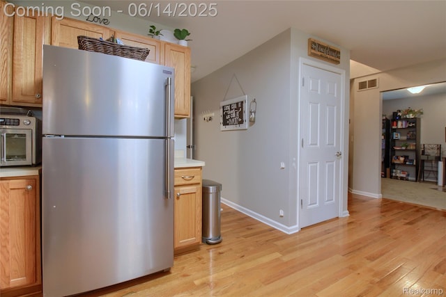 31626 Beaver Cir, New Boston, MI 48164 - kitchen with freestanding refrigerator, light wood-style floors, and light countertops