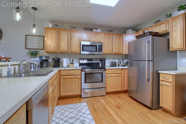31626 Beaver Cir, New Boston, MI 48164 - kitchen featuring appliances with stainless steel finishes, light countertops, light wood-style floors, decorative light fixtures, and light brown cabinetry