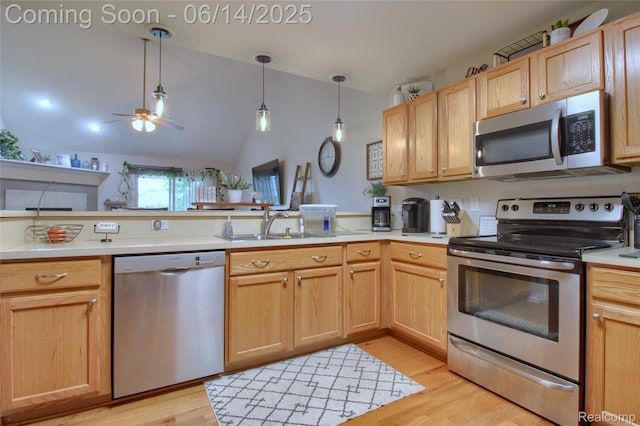 31626 Beaver Cir, New Boston, MI 48164 - kitchen featuring appliances with stainless steel finishes, lofted ceiling, a peninsula, ceiling fan, and light wood finished floors