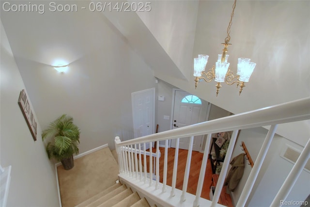 31626 Beaver Cir, New Boston, MI 48164 - staircase with a chandelier, a high ceiling, and wood finished floors