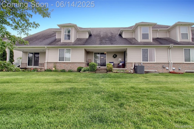 31626 Beaver Cir, New Boston, MI 48164 - view of front of property with brick siding, a front yard, a shingled roof, and covered porch