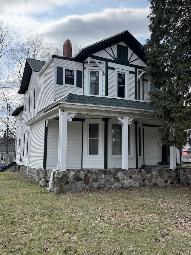 205 Main St, Dowagiac, MI 49047 - view of front of house with a chimney, a porch, and a front yard