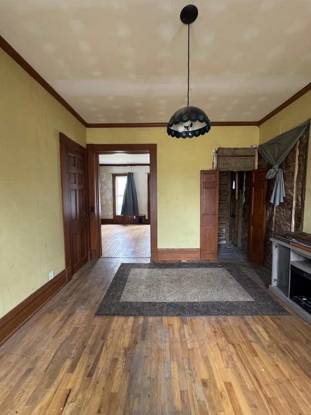 205 Main St, Dowagiac, MI 49047 - unfurnished dining area featuring hardwood / wood-style flooring, baseboards, and crown molding
