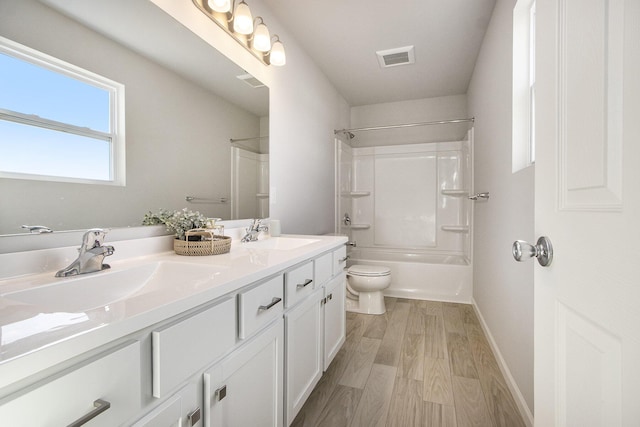 608 Arizona Blvd, Three Rivers, MI 49093 - full bathroom with double vanity, toilet, wood finished floors,  shower combination, and baseboards