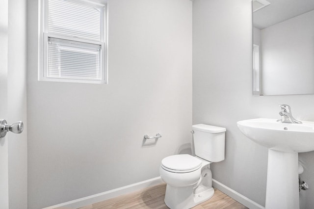 608 Arizona Blvd, Three Rivers, MI 49093 - bathroom featuring toilet, wood finished floors, baseboards, and a sink