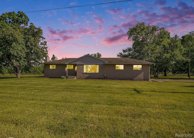 12105 Hegel Rd, Goodrich, MI 48438 - back of property featuring a yard, a chimney, and brick siding