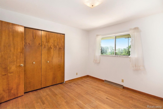12105 Hegel Rd, Goodrich, MI 48438 - unfurnished bedroom featuring light wood-style floors and a closet
