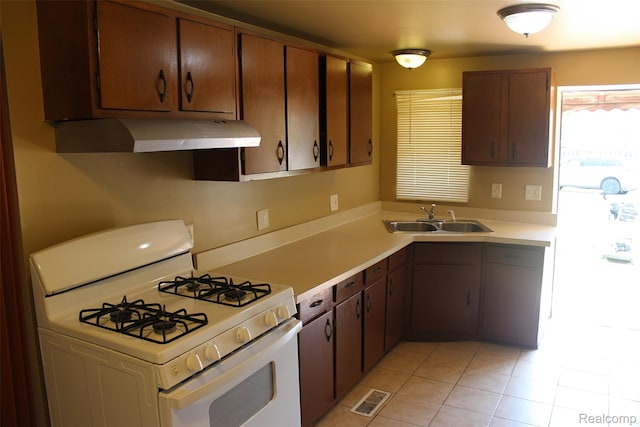 15504 Chelsea, Redford, MI 48239 - kitchen featuring white gas stove, extractor fan, a sink, light tile patterned floors, and light countertops