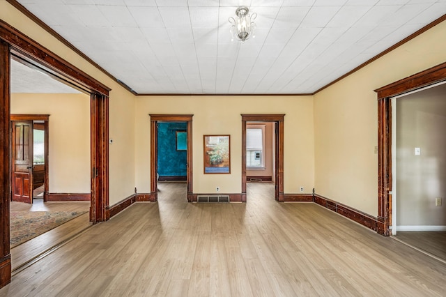 920 Wisconsin Ave, Saint Joseph, MI 49085 - empty room with crown molding, light wood-style flooring, and baseboards