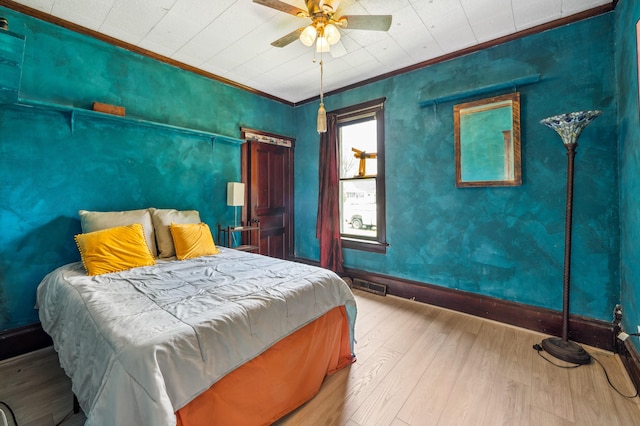 920 Wisconsin Ave, Saint Joseph, MI 49085 - bedroom featuring wood finished floors, baseboards, ornamental molding, and ceiling fan