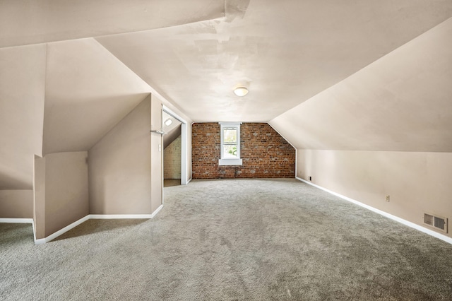 920 Wisconsin Ave, Saint Joseph, MI 49085 - additional living space featuring brick wall, baseboards, carpet floors, and lofted ceiling