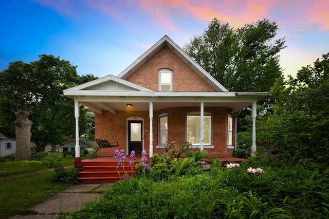 920 Wisconsin Ave, Saint Joseph, MI 49085 - view of front of house featuring a porch and brick siding