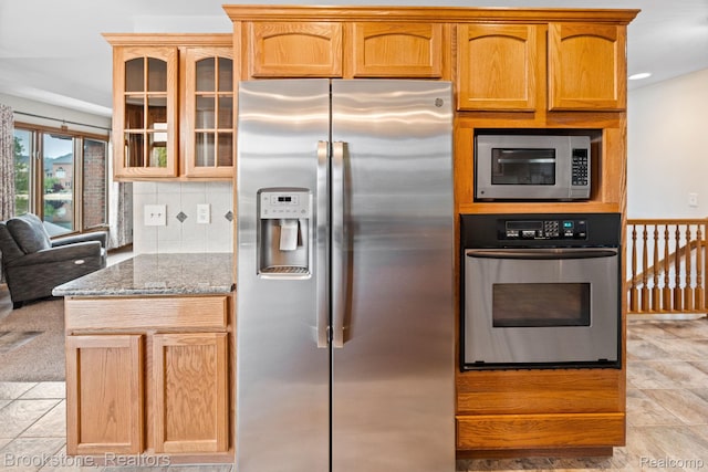 26569 Autumn Lake Dr, Chesterfield, MI 48051 - kitchen featuring appliances with stainless steel finishes, light stone counters, glass insert cabinets, and tasteful backsplash