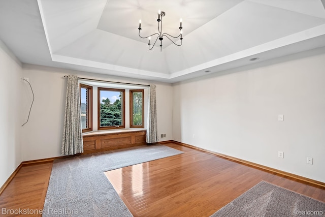 26569 Autumn Lake Dr, Chesterfield, MI 48051 - empty room with a tray ceiling, a chandelier, and baseboards