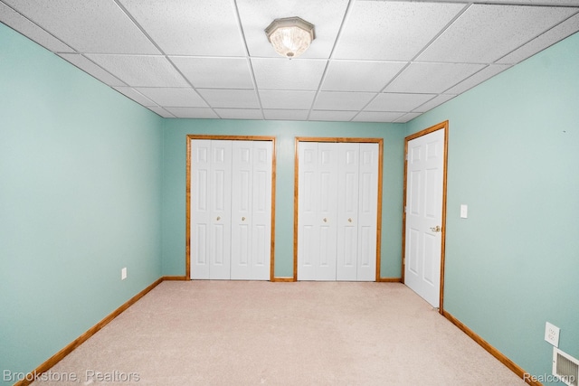 26569 Autumn Lake Dr, Chesterfield, MI 48051 - unfurnished bedroom with light colored carpet, multiple closets, baseboards, and a drop ceiling