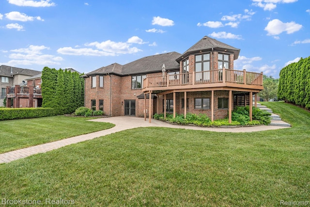 26569 Autumn Lake Dr, Chesterfield, MI 48051 - rear view of house featuring brick siding, a deck, a yard, and a patio area