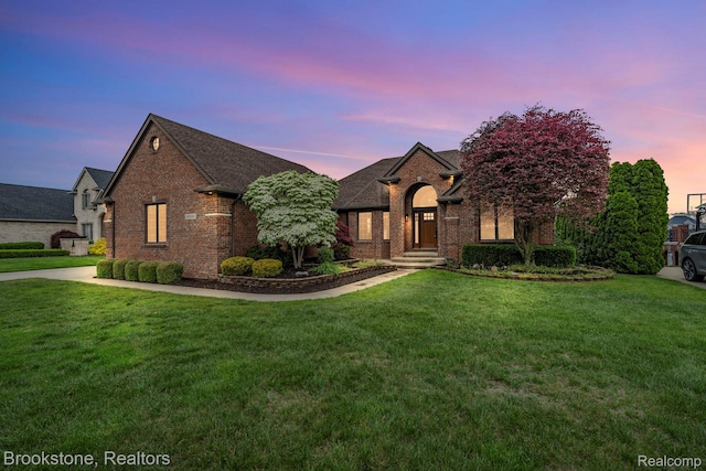 26569 Autumn Lake Dr, Chesterfield, MI 48051 - french country inspired facade featuring a front lawn, brick siding, and a shingled roof