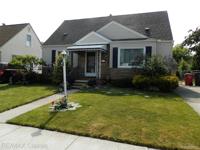 25207 Fortuna St, Roseville, MI 48066 - view of front facade with roof with shingles and stone siding