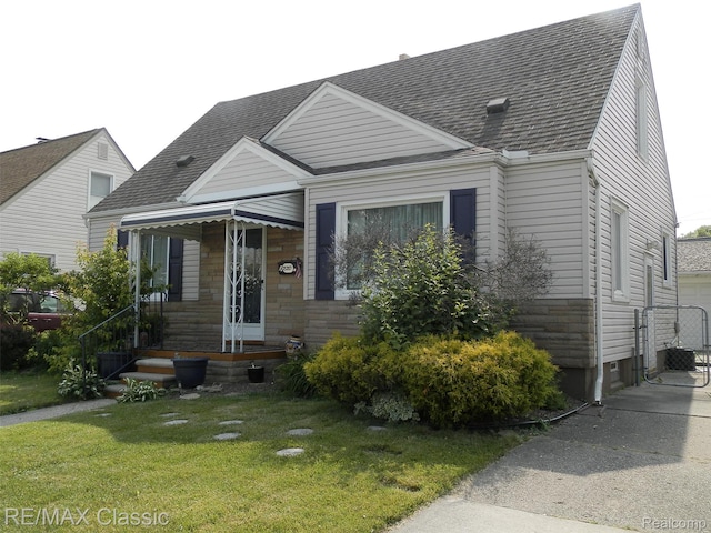 25207 Fortuna St, Roseville, MI 48066 - view of front of home featuring a front lawn, roof with shingles, stone siding, and a gate